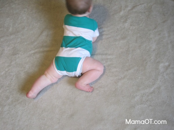 Babies start experimenting with bringing one knee up to the trunk in an effort to scoot forward on their tummy between approximately 6-8 months. #childdevelopment #pediOT #mamaot