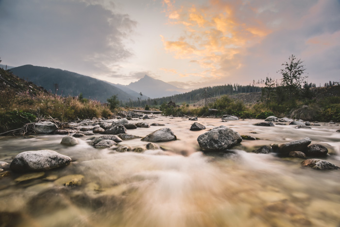 A landscape scene focusing on soft misty flowing river - golden spiral vs rule of thirds