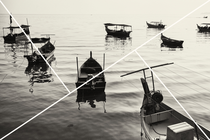 Black and white image of boats in water with composition overlay 
