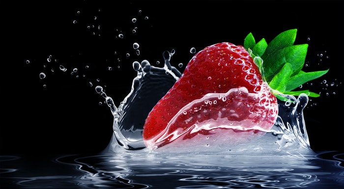 A strawberry splashing in water