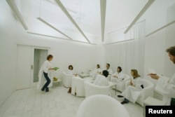 In Sweden, where lack of winter sunlight can contribute to depression, customers dressed in white robes take in simulated sunlight at Stockholm