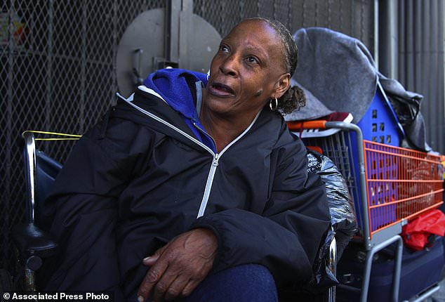 Lawana Tillman sits in a wheelchair with her belongings in San Francisco. Tillman camps out in a wheelchair with friends on a corner they