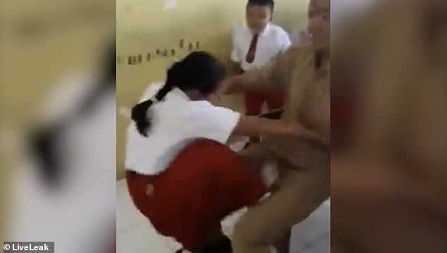 The schoolgirl kicks her teacher in the groin as she tries to get out of having a flu jab
