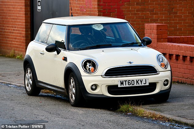 The neighbourhood officer suffered head and leg injuries after being hit when he tried to stop a white Mini (pictured after it was dumped 500 metres away)