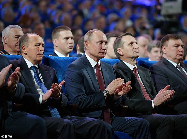 At about the same time as the shooting happened, Putin (pictured center with other Russian officials this afternoon), a KGB veteran, made a speech at a Kremlin concert for FSB and other Russian security personnel