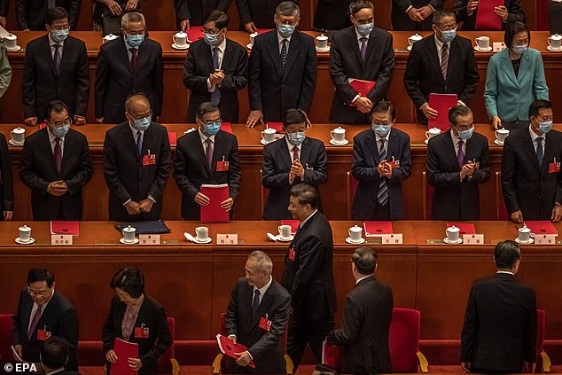 Pictured: Chinese President Xi Jinping (C, bottom) walks past applauding delegates, May 28. The new law gives Beijing sweeping powers over Hong Kong, and sparked global outrage
