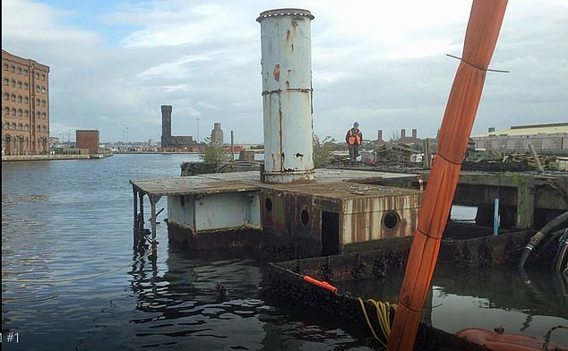 The 300-ton vessel Landfall, which managed to avoid a D-Day German shell fire attack, sank in a Merseyside dock in 2010 (pictured partly submerged in Birkenhead)
