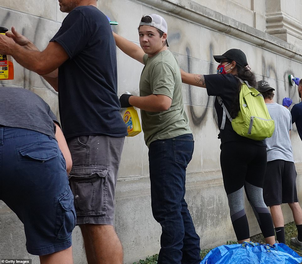Rittenhouse was among the volunteers spotted earlier on Tuesday cleaning graffiti from a high school near the Kenosha County Courthouse following another night of unrest in the city