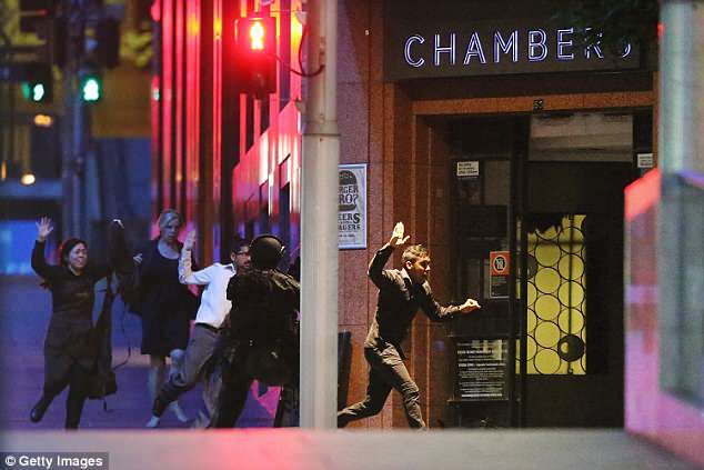 Hostages run from the Lindt Cafe in Sydney