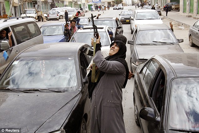 Conflict: A Libyan rebel fighter as she heard Colonel Gaddafi