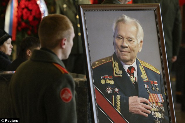 Final respects: A military cadet stops to look at a portrait of Mikhail Kalashnikov during his funeral service