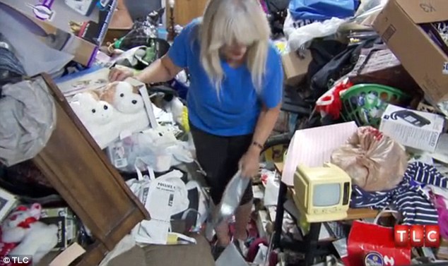 Health hazard: Her home is now stacked floor-to-ceiling with items and the floor is no longer visible