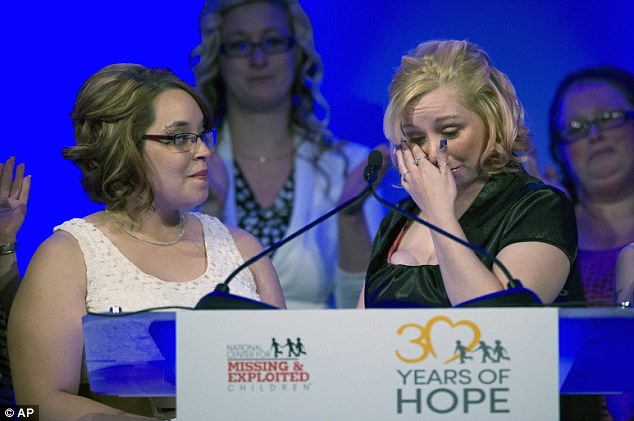 On the one-year anniversary of their escape, Amanda Berry, right, wipes tears from her eyes with Georgina DeJesus by her side as they are honored at the National Center for Missing and Exploited Children