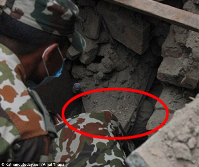 The gap showing the hole where the baby was buried alive for nearly one whole day after his home collapsed