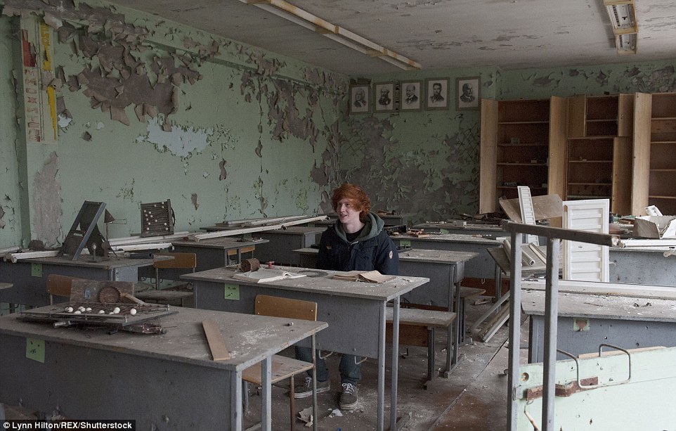 Tour guides claim they instruct visitors not to disturb the site, but tourists pose for photos inside abandoned classrooms at one school