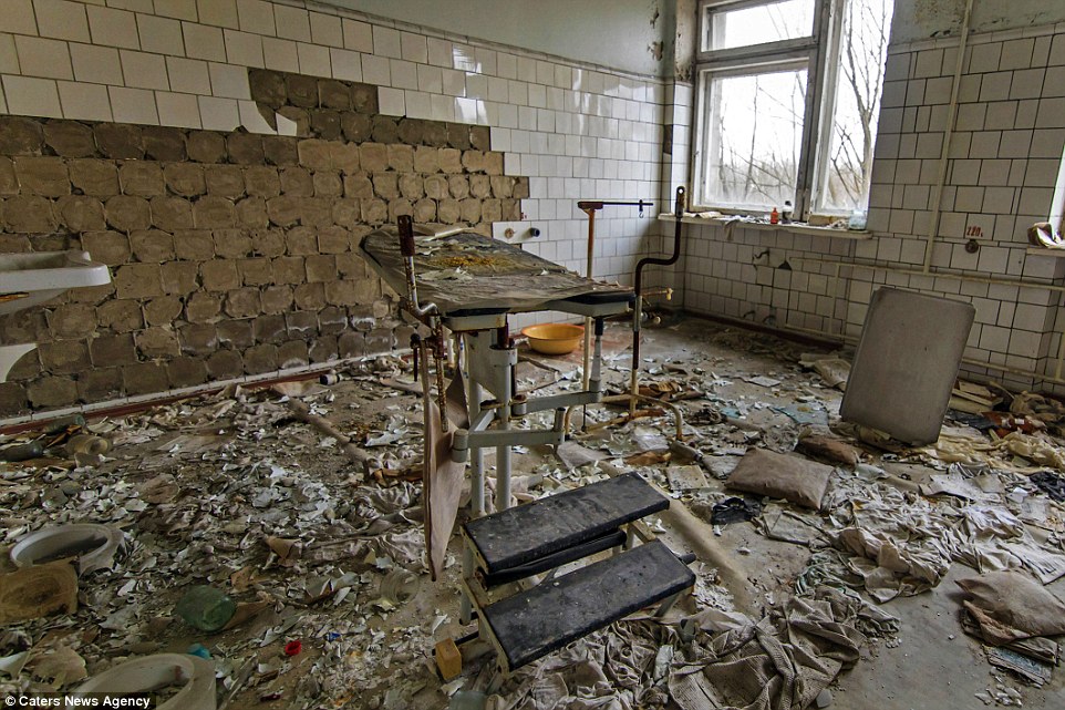 Desolate: A hospital treatment room is rotten and dilapidated as the bed in the middle is surrounded by debris and old belongings and the tiles fall off the walls