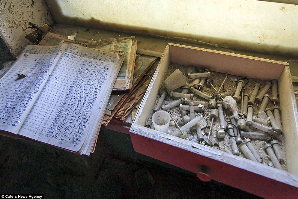 Creepy: Glass syringes for consumption drugs and records of administration are left discarded on hospital shelves after one of the reactors deep inside the Chernobyl power plant went into meltdown