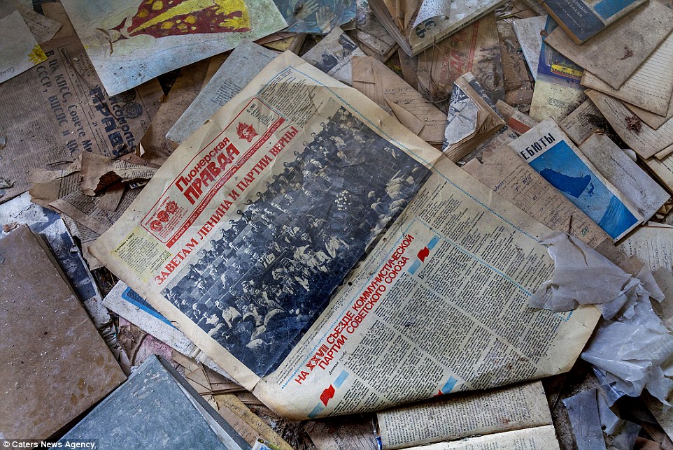 Poignant: Newspapers and books litter the floors of abandoned homes in a reminder that this was once a vibrant town full of thriving scientists, businesses and families