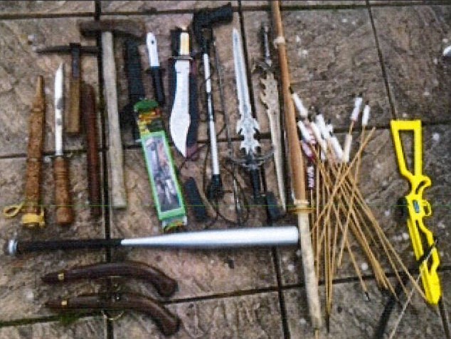 Arsenal of weapons: Police searched an area of woodland and heard the sound of chopping wood, before finding Joyner sitting next to a small tent with a bow, arrows, axes, cut throat razors and a machete