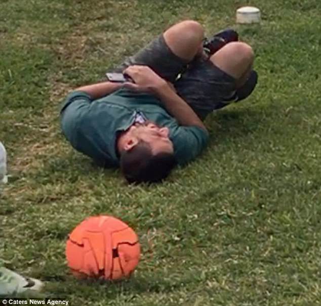 Jimmy Penna fell to the ground in agony after one of the youngsters booted the ball at him at point-blank range