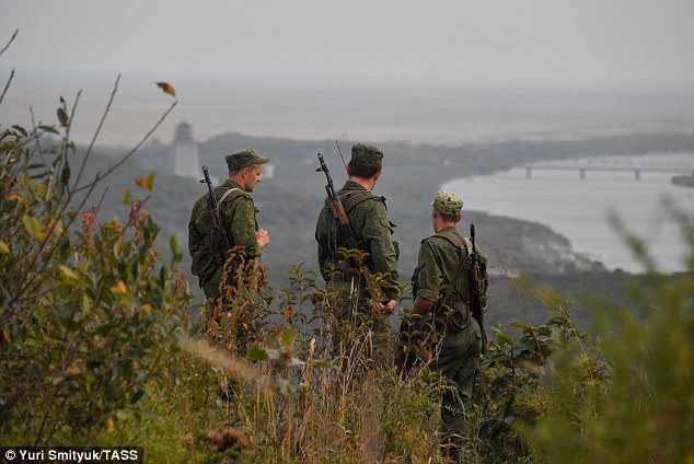 Russian border guards patrolling the top of Zaozyornaya Hill at the Khasan crossing point on the Russian-North Korean border in the tri-border area where the boundaries of Russia, China and North Korea meet