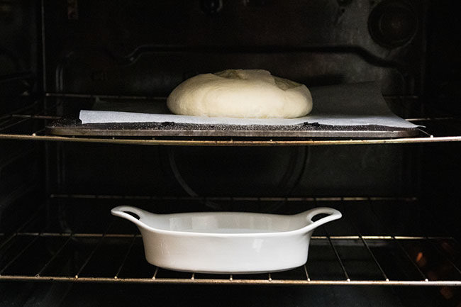 bread dough baking on a baking steel in the oven