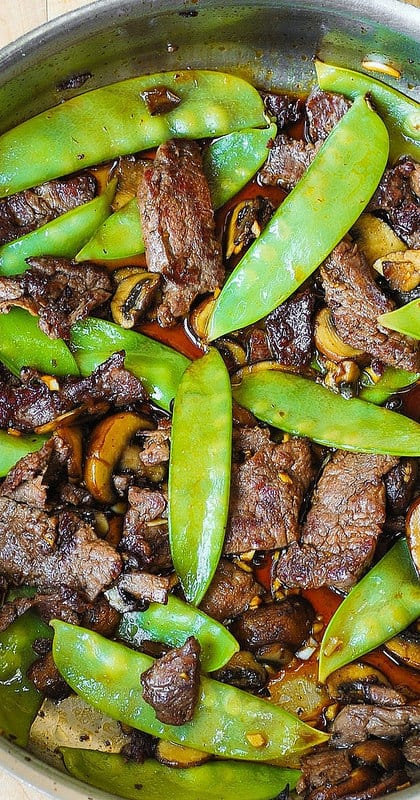 Asian Beef with Mushrooms and Snow Peas in a skillet