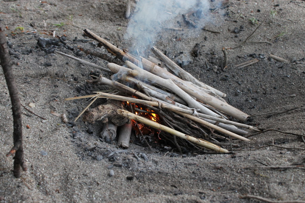 The lean-to fire lay keeps the tinder and lower-levels of kindling dry.