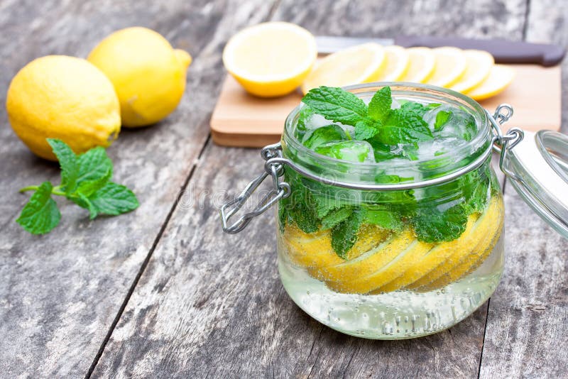 Homemade fruit drink with lemon mint and ice on the table royalty free stock photo