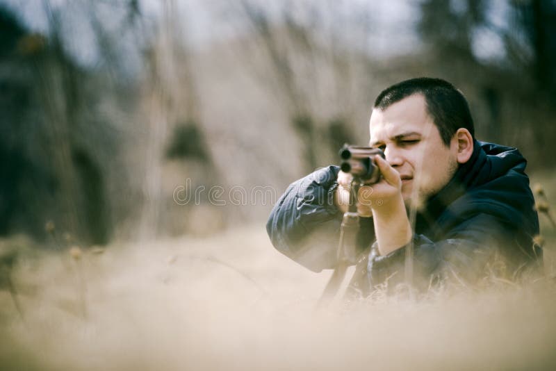 Hunter Aiming Gun stock photography