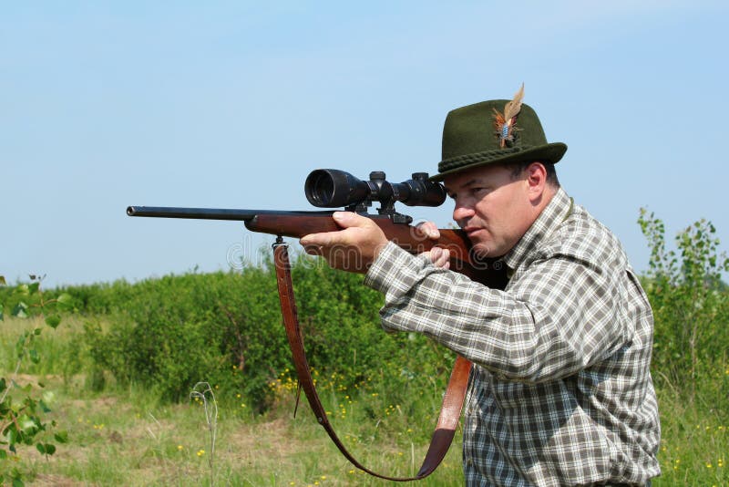 Hunter aiming with rifle stock photography