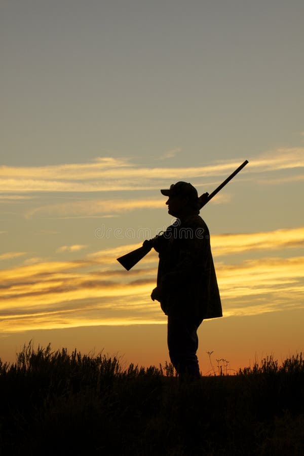 Hunter With Shotgun in Sunset royalty free stock image