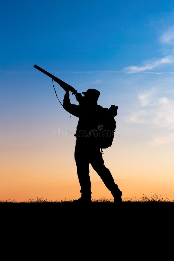 Hunter with shotgun in sunset stock image