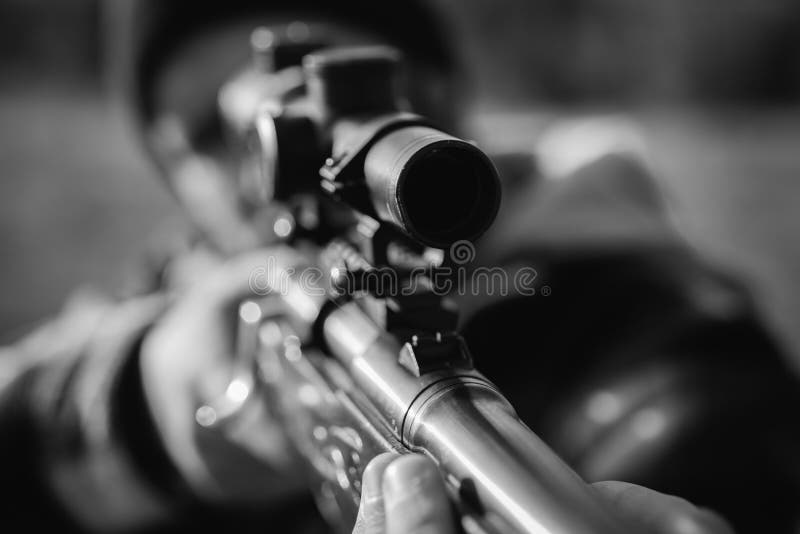 Hunting Poacher in the Forest. Hunter with shotgun gun on hunt. Hunter aiming rifle in forest. Track down. Black and stock photo