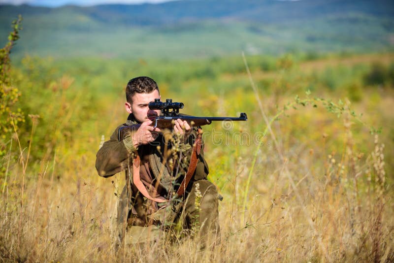 Man hunter aiming rifle nature background. Guy hunting nature environment. Hunting weapon gun or rifle. Hunting target royalty free stock photography