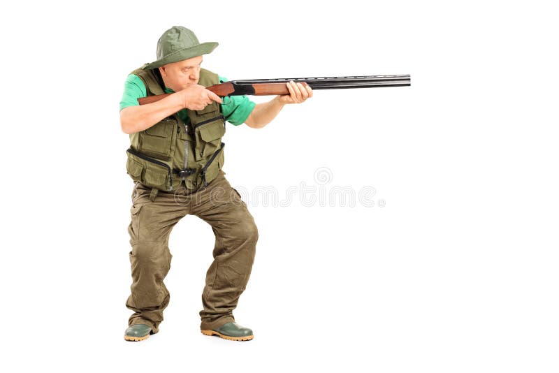 Mature hunter aiming at something with a gun stock photos