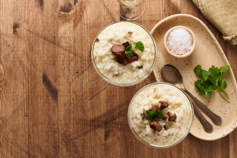 Risotto with mushrooms in wine glass. Unconventional unusual serving. Top view, copy space royalty free stock photos