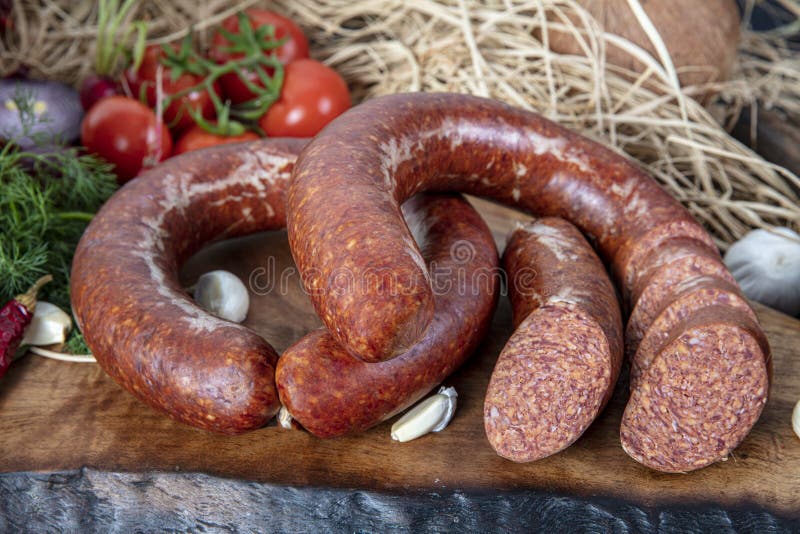 Turkish sausage kangal sucuk. Sujuk sucuk, a dry spicy sausage on wooden background stock image
