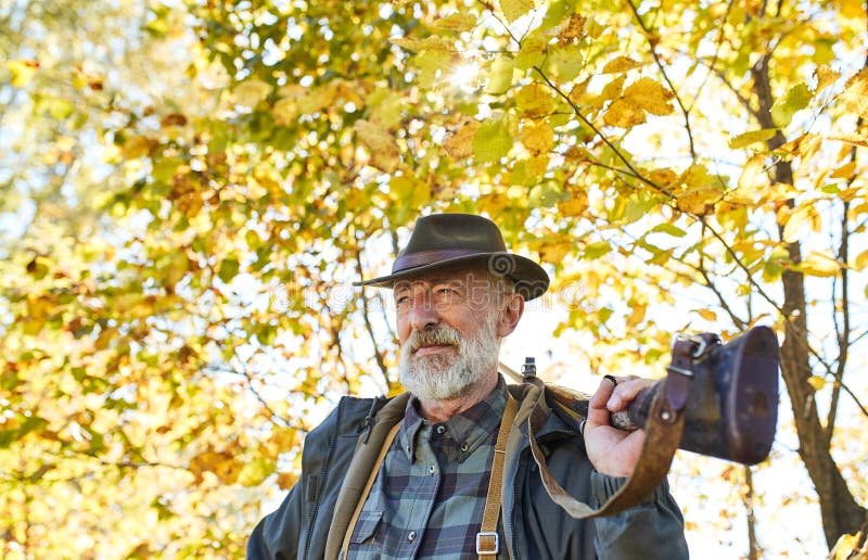 Senior hunter carry rifle gun on shoulder stock photos
