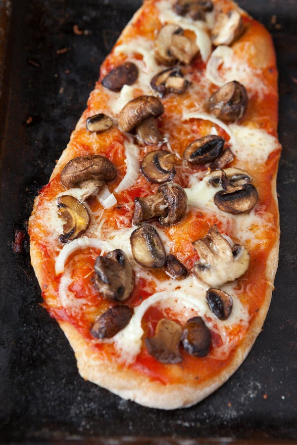 Unusual pizza with mushrooms and tomato sauce stock photography