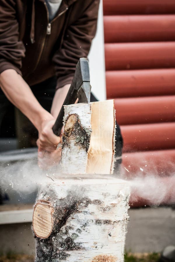 Wood chopping with hand axe royalty free stock photo