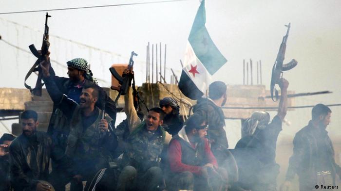Members of the Free Syrian Army shout slogans against Syrian President Bashar al-Assad