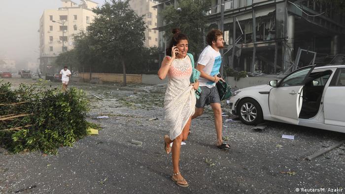 Man and woman running in Beirut (Reuters/M. Azakir)