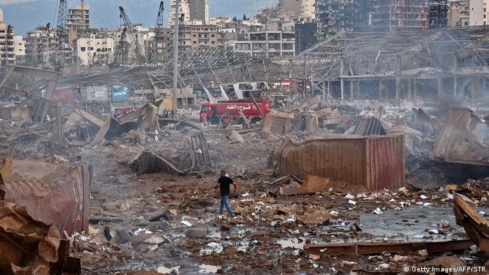 Aftermath of Beirut blasts, man walks through rubble 