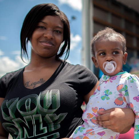 Mother holds baby daughter