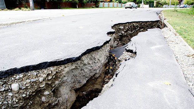 Photo of ground displacement (massive crack in a road) after an earthquake